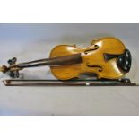 A violin with a walnut finger board bearing no labels, 57cm long max, 19cm wide max, the bow stamped