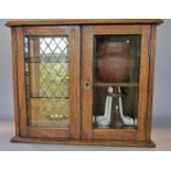 An oak smokers cabinet with double glazed drawers and drawers to the interior, a spinning pipe rack,