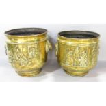 A pair of brass coal buckets with embossed tavern scenes and lion mask handles (one lacks ring) 26cm