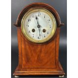 An Edwardian mahogany mantle clock, the case with swept outline and string banded inlay, enclosing