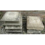 A set of four weathered stone pier caps a of squat square stepped form, 45cm square, together with