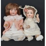 2 early 20th century German bisque head character baby dolls by Armand Marseille, both in period