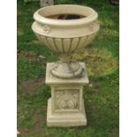 A weathered classical garden urn, the circular lobed bowl with fixed socle cemented on a squat