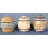 Three Doulton Lambeth tobacco jars and covers with slightly varying details