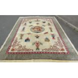 A large Chinese rug with central dragon medallion and motifs of lotus flowers, censers, urns and