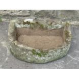 A small weathered D shaped natural stone trough with drainage hole 51 cm wide x 40 cm deep x 17 cm