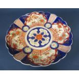 19th century Imari charger with fluted borders with typical pallet and repeating floral panels, 48