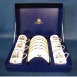 A cased set of six Royal Worcester floral patterned coffee cans and saucers