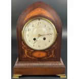 An inlaid Edwardian mahogany mantle clock, the case of lancet shape with marquetry detail with