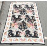 A Kashmiri hand stitched wool wall hanging, with an overall pattern of pastel coloured flowers on