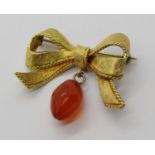 Vintage 18ct bow brooch maker 'RHB', with attached carnelian bead drop, 8.7g