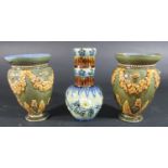 A pair of Doulton Lambeth oviform vases with repeating floral swag detail and acanthus leaves on