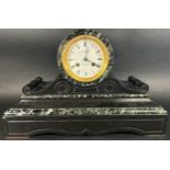 A 19th century marble and black slate mantle clock with drum head enclosing a French eight day