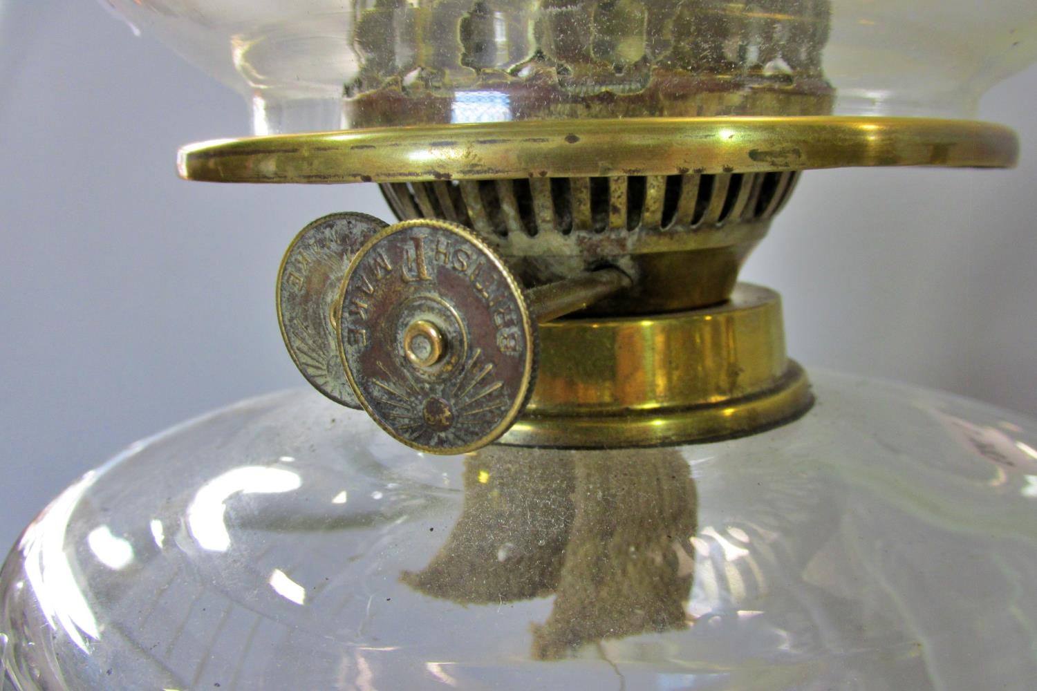 A Victorian brass oil lamp on a spread foot, with clear glass font and frosted garland decorated - Image 2 of 2