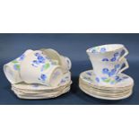 A Colclough tea service in an art deco style for six with blue flower detail together with a small