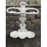 A cast iron stick stand with shaped and detailed outline and painted finish