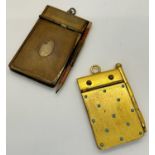 A gold plated pocket notebook inlaid with turquoise and a further example with engine turned detail,