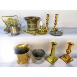 A selection of brass ware including two pestles, a mortar, a pair of candlesticks, two further