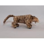 Vintage clockwork tiger by Louis Marx circa 1950 with growling and prowling action when wound. Plush