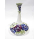 A Macintyre/William Moorcroft vase, the base of circular compressed form with drawn neck,