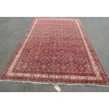 A Persian Hamadan Rug with all-over repeating pattern on a scarlet ground, approx. 280 x 190 cm