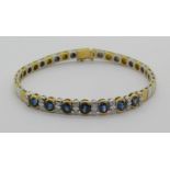 18ct bi-colour bracelet set with oval sapphires and circular diamonds, 19.2cm L approx excluding