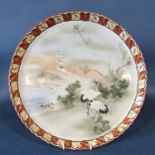A Japanese ceramic tray, circular, the central panel cranes, prunus blossom in landscape within a