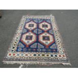 A Middle-Eastern Rug with four central quadrants on a blue ground, approx. 200 x 140 cm