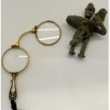 A pair of Victorian lorgnette with bright enamel detail and gilded framework and a primitive