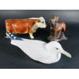 A Copenhagen model of a seagull together with a Hereford cow and a model of a Labrador with game