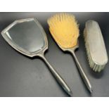 An engine turned silver brush mirror and comb set, five teaspoons, two napkin rings and a single