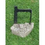 A simple old iron work boot scraper set in a stone base, 36 cm high x 30 cm, full width including