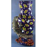 A substantial majolica floor standing vase, the body of blue ground with scrolling clouds and