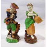 A pair of 19th century continental figures depicting a country boy with rabbit in his bag against