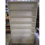 A painted floor standing open bookcase with fixed shelves 117cm w 206cm h