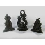 Three Victorian cast iron doorstops in order of size, a fox hunting theme, an 18th century