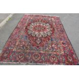 An old Persian Bakhtiar rug with a central floral medallion and traditional tones, 280 x 210 cm