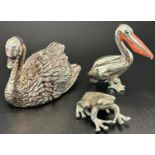 A collection of silver miniatures comprising a swan, a frog, a pelican with enamel beak and a gun,