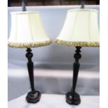 A pair of octagonal faceted bronze effect composite table lamps on a stepped base, both with