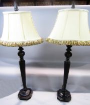 A pair of octagonal faceted bronze effect composite table lamps on a stepped base, both with