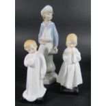 Two Royal Doulton figures, Bedtime Prayers and Darling and a further Lladro figure of a boy with a