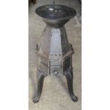 An old continental floor standing stove, with flat irons the central tray stamped M. Martin, 83cm