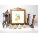 A wall clock with an old coloured botanical print of oranges set in a wooden glazed frame with