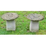 A pair of weathered cast composition stone small squat staddlestones and caps, 45cm diameter x