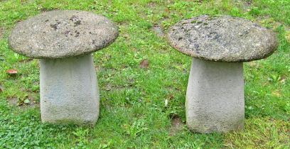A pair of weathered cast composition stone small squat staddlestones and caps, 45cm diameter x