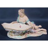 A large 19th century Meissen figural porcelain sweetmeat dish, modelled with reclining maiden,