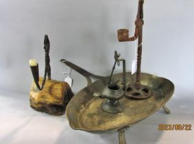 Two wrought iron 19th century nip/rush light holders, one set in a chunk of wood.