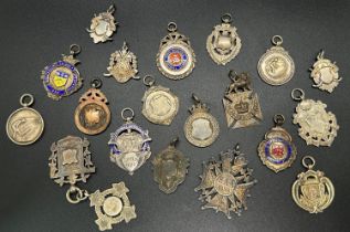 A collection of 20 silver sports medals including football, cricket, boules, swimming, etc, some