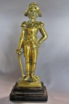 A 19th century brass door stop of a military gentleman raised on a stepped cast iron base and a