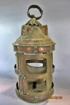 A circular copper candle lantern in need of restoration and a scrolled metal lantern also in need of